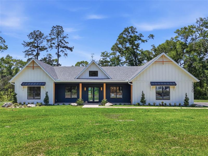 Front exterior of a new home in , Newberry, FL, highlighting curb appeal (Image 25).