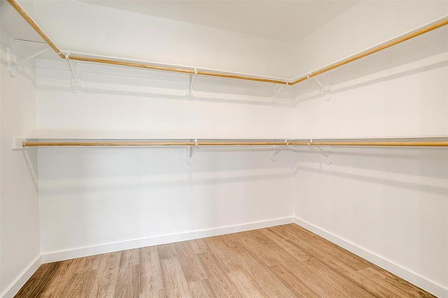 Spacious closet with hardwood / wood-style floors Spacious closet with hardwood / wood-style floors