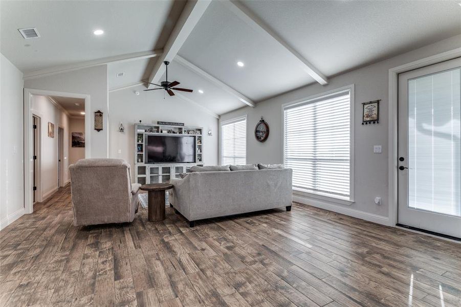 Living area featuring wood finished floors, a ceiling fan, and recessed lighting