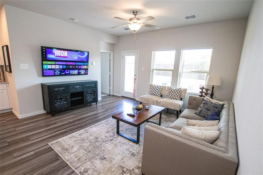 Living room with ceiling fan and wood finished floors Living room with ceiling fan and wood finished floors