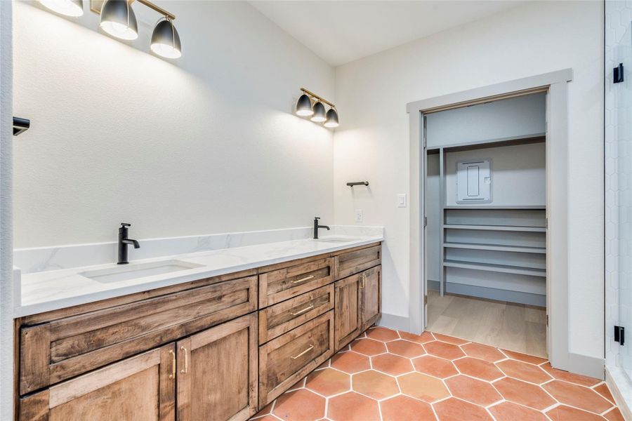 Bathroom featuring double vanity and light tile patterned flooring