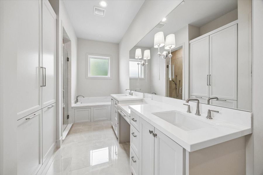 The second-floor primary bath features dual vanities, a soaking tub, and a separate shower, creating a comfortable retreat for the upstairs primary suite. The second-floor primary bath features dual vanities, a soaking tub, and a separate shower, creating a comfortable retreat for the upstairs primary suite.