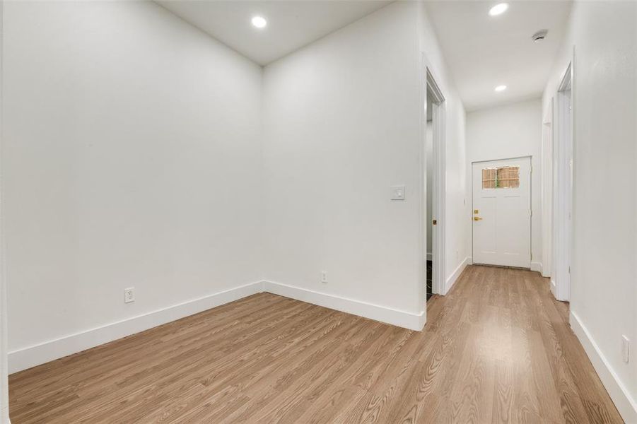 Empty room featuring light wood-style flooring and recessed lighting Empty room featuring light wood-style flooring and recessed lighting