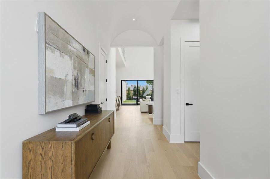 Bright interior hallway featuring light wood-finish flooring Bright interior hallway featuring light wood-finish flooring