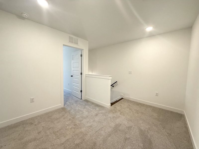 Unfurnished room with light colored carpet, recessed lighting, and a smoke detector