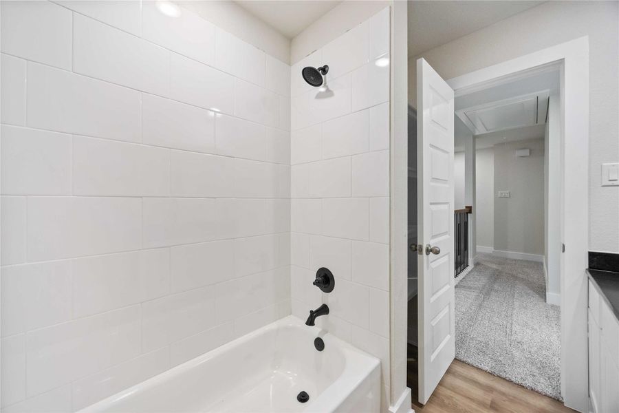 Enjoy this gorgeous bathroom with matte black finishes and tiled shower walls.