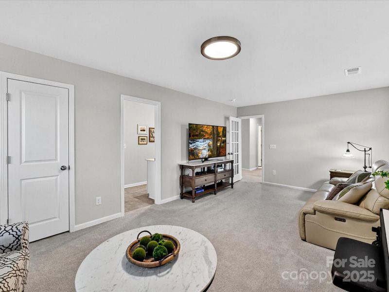Upper Level Laundry with Tiled Flooring and Shelving