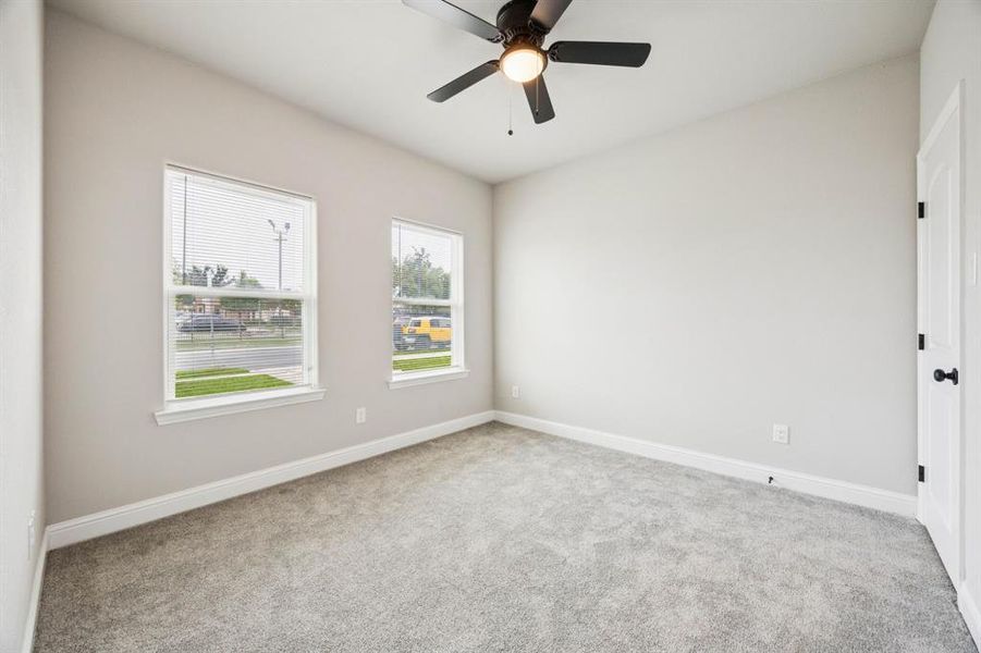 (Bedroom #3) bedroom featuring light carpet, walk-in closet and a ceiling fan