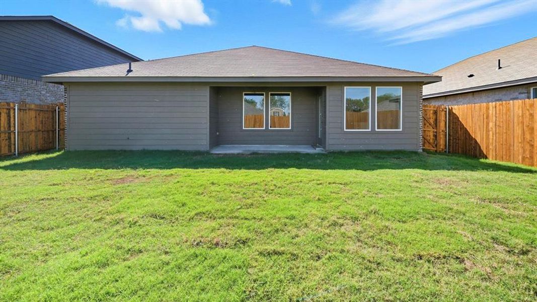 Rear view of property with a fenced backyard, a patio area, and roof with shingles Rear view of property with a fenced backyard, a patio area, and roof with shingles