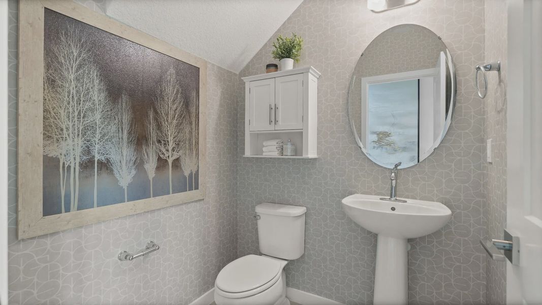 Downstairs Half Bathroom of a DRB Homes Jupiter Model at Grasslands West in Lakeland, FL.
