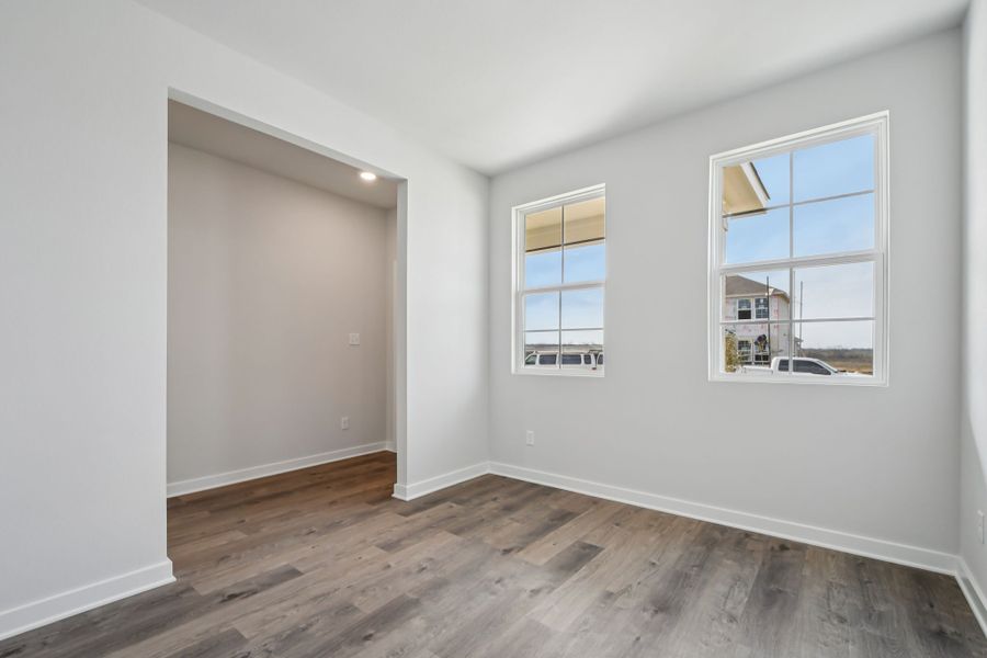 A room with a wood floor and a window.