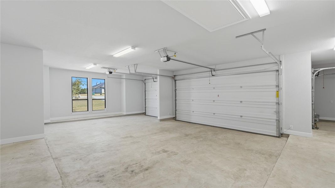 Garage featuring baseboards Garage featuring baseboards