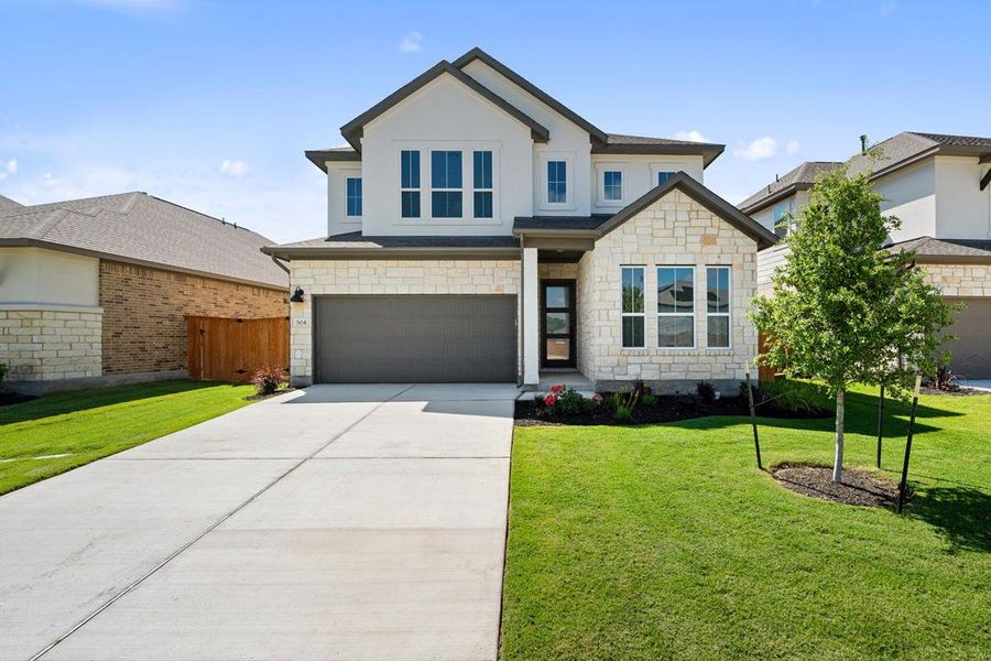 Front exterior of a new home in Lariat, Liberty Hill, TX, highlighting curb appeal (Image 21). Front exterior of a new home in Lariat, Liberty Hill, TX, highlighting curb appeal (Image 21).