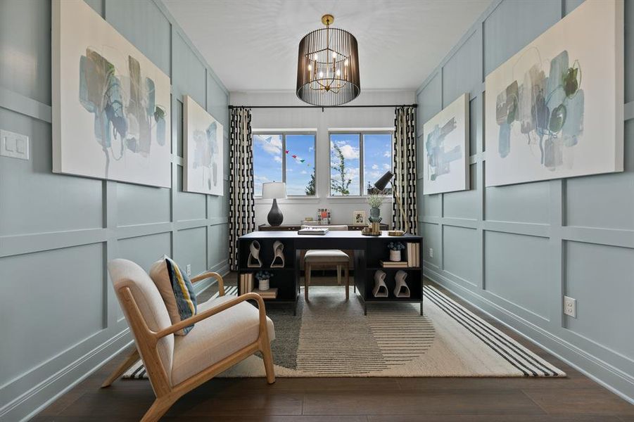 Office space with a decorative wall, suspended lighting, and dark wood-style flooring Office space with a decorative wall, suspended lighting, and dark wood-style flooring