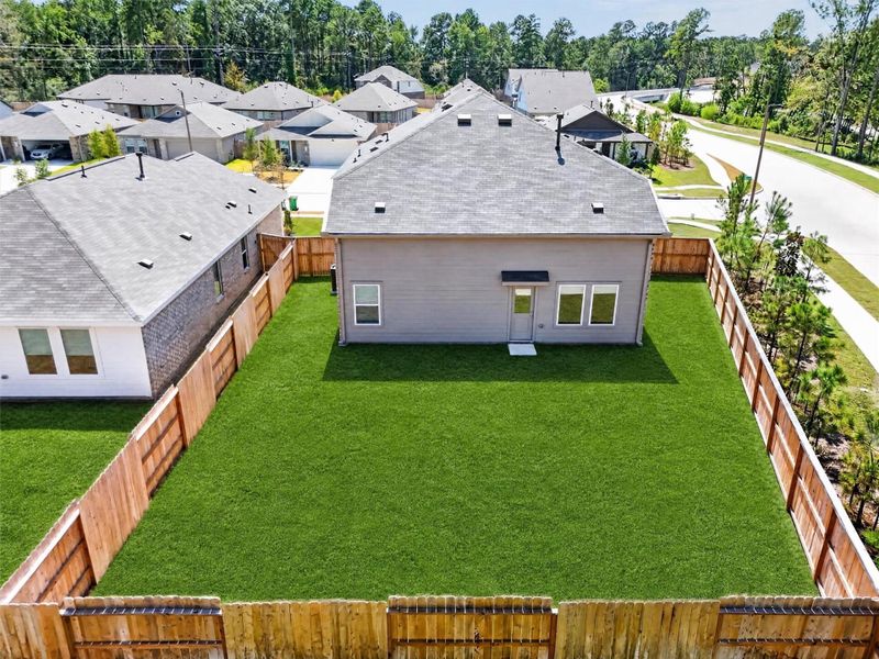 The spacious fenced backyard offers room to relax, play, and enjoy the outdoors. Grass is virtually enhanced