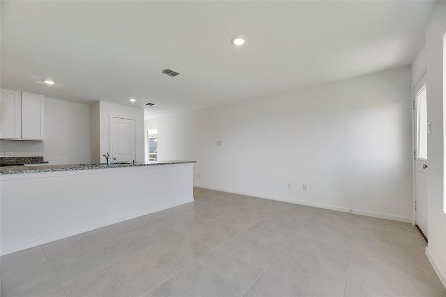 Unfurnished living room with light tile patterned flooring