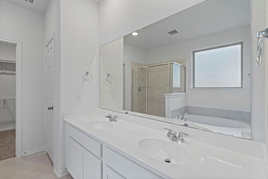 The en-suite bathroom offers a spa-like atmosphere with its elegant design, high end finishes, and tasteful lighting, creating a retreat within your own home. The en-suite bathroom offers a spa-like atmosphere with its elegant design, high end finishes, and tasteful lighting, creating a retreat within your own home.