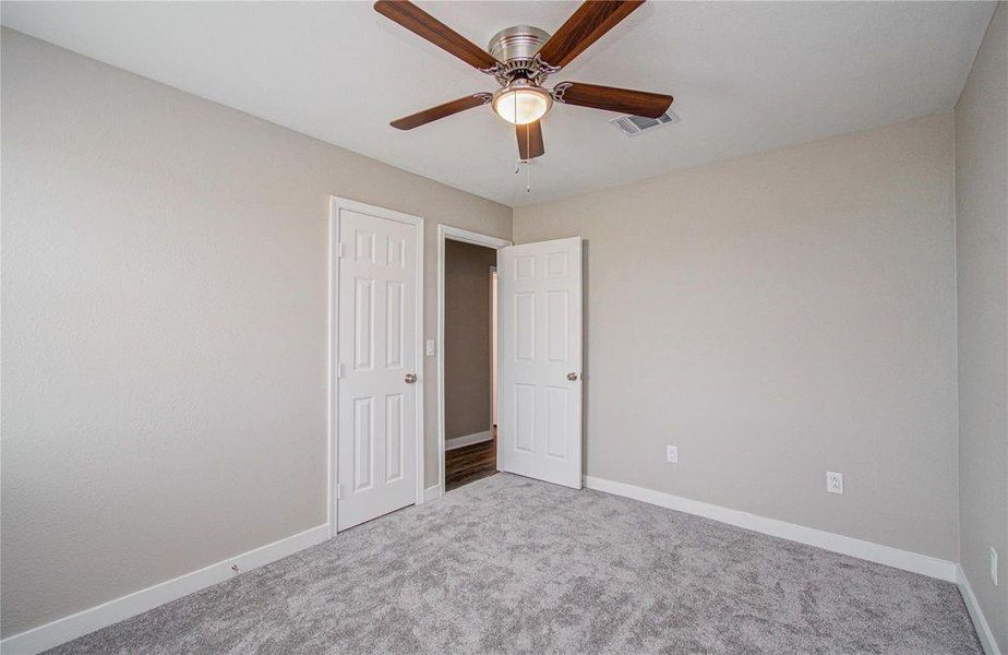 Bedroom 2 view to hallway. Updated carpet, light fixtures and private closet.