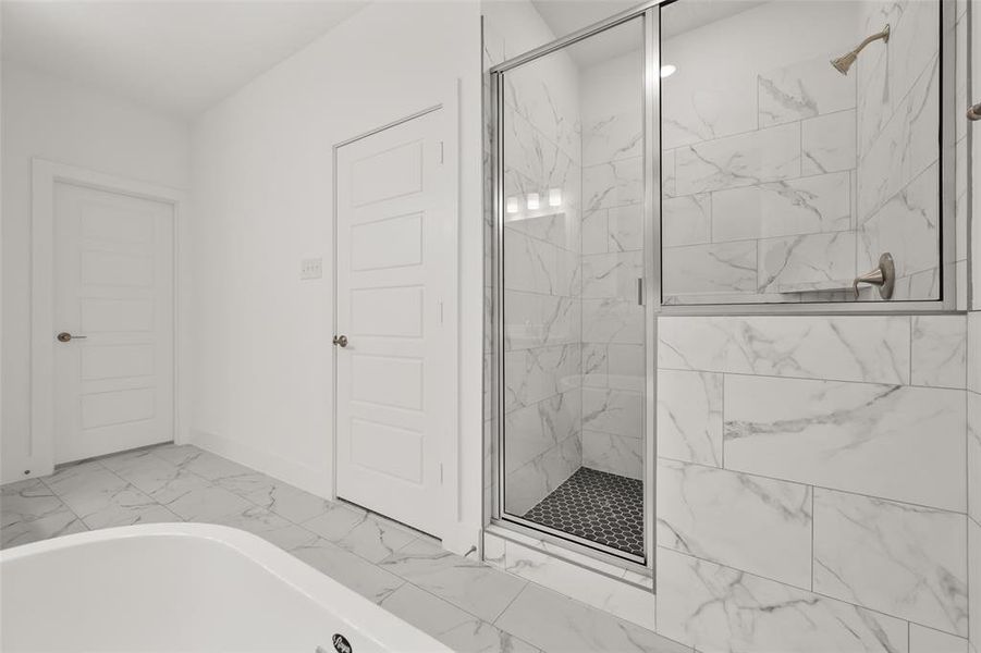 Primary bathroom with two sinks, tile floors, and a separate shower and tub.