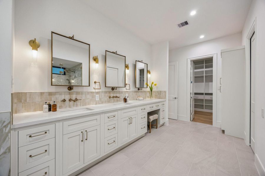 Another view of the Primary Bathroom which also features a storage closet for towels and toiletries.