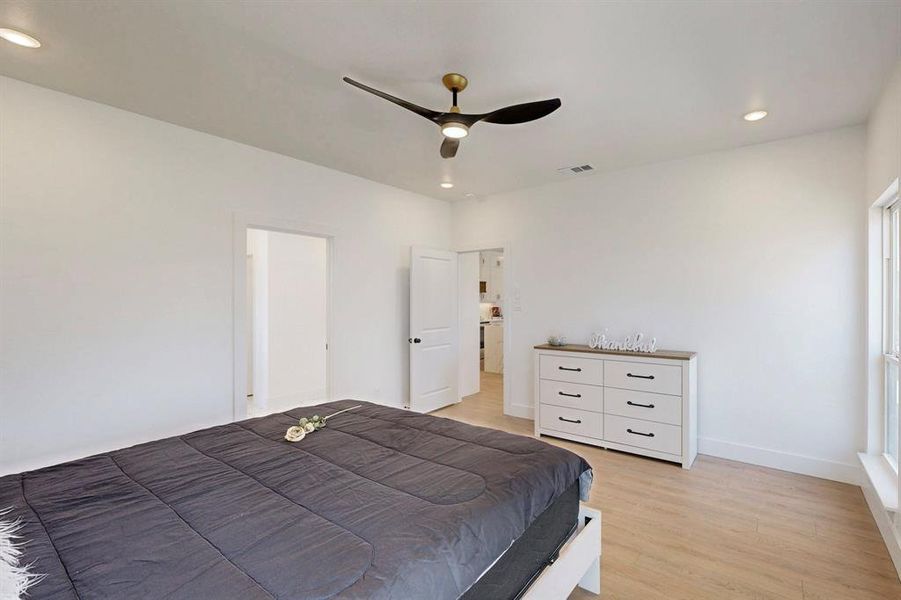 Bedroom with ceiling fan and light hardwood / wood-style floors