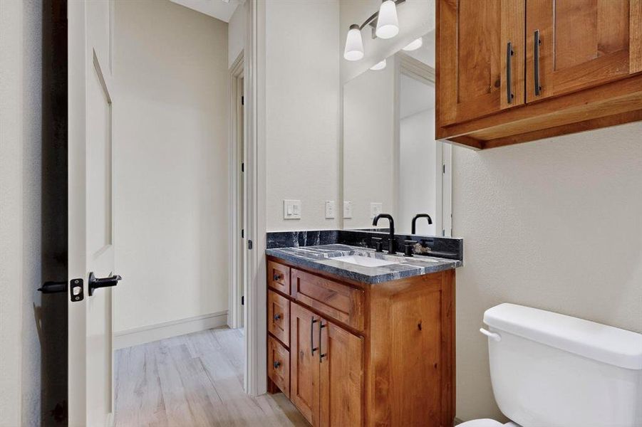 Half bathroom with vanity and light wood finished floors Half bathroom with vanity and light wood finished floors