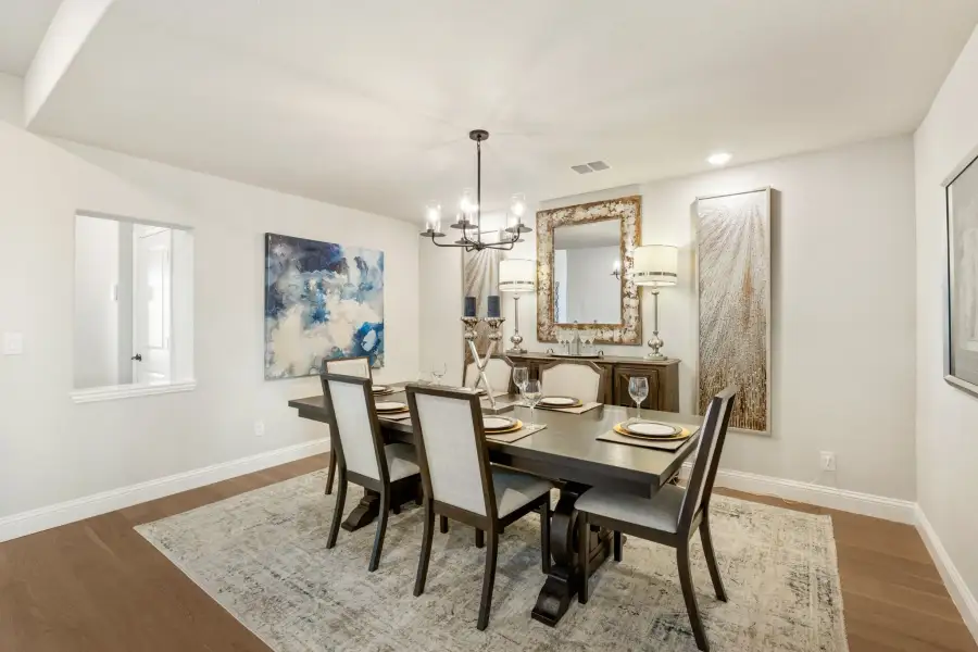 Formal dining room with dark wood table, six chairs, chandelier, and hardwood floors