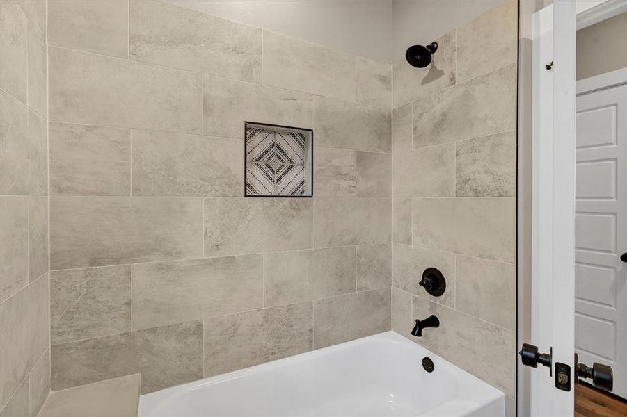 Full bath featuring bathing tub / shower combination