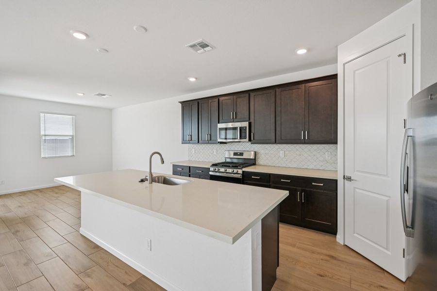 Kitchen and dining. Finishes and options may vary by community