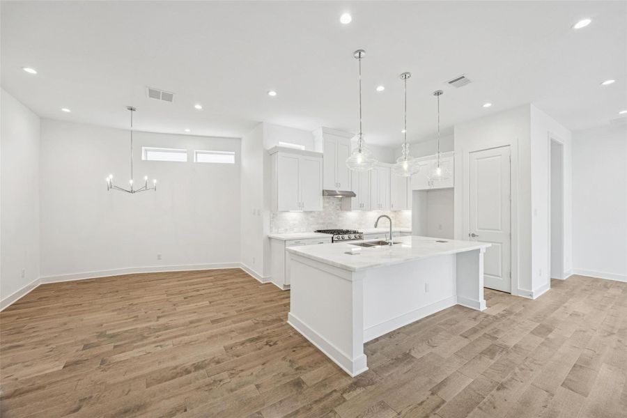 All Open * Kitchen is Light and Bright * White Cabinets * Marble Counters * Stainless Steel Appliances.