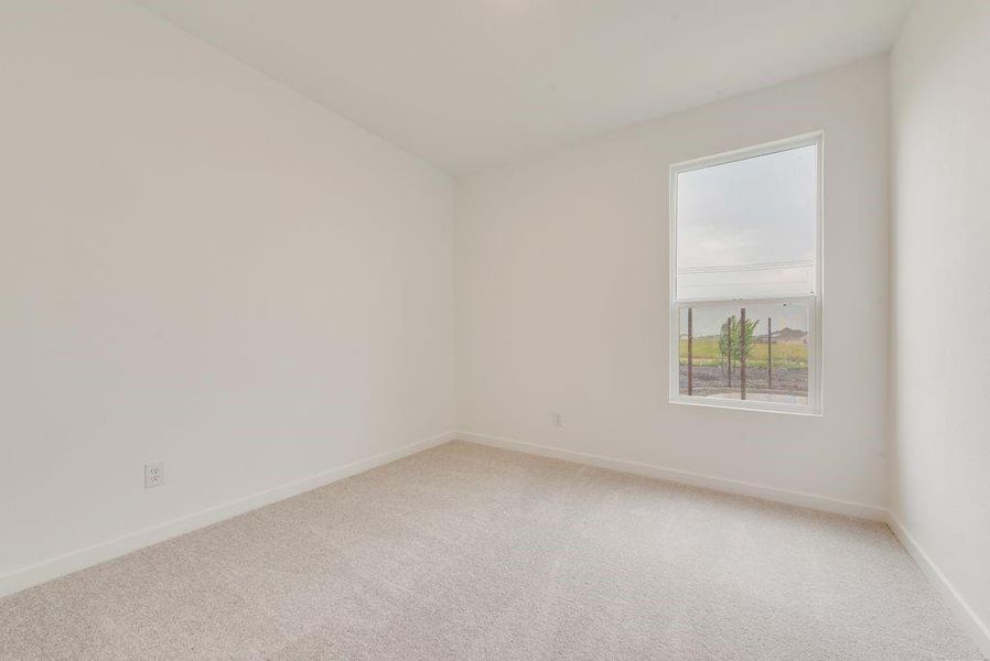 Empty room featuring light carpet