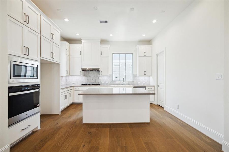 Tall ceilings and natural light with Large Kitchen area. Beautiful dual tone cabinets and easy to maintain quartz countertops