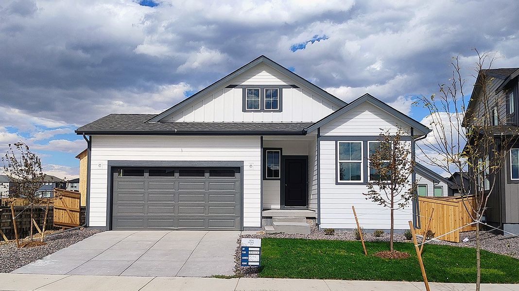 Front exterior of a new home in The Cottages Collection at Ridgeline Vista, Brighton, CO, highlighting curb appeal (Image 1).
