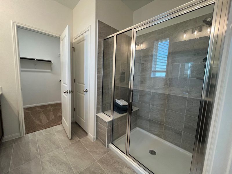 large oversized walk-in shower with quartz bench
