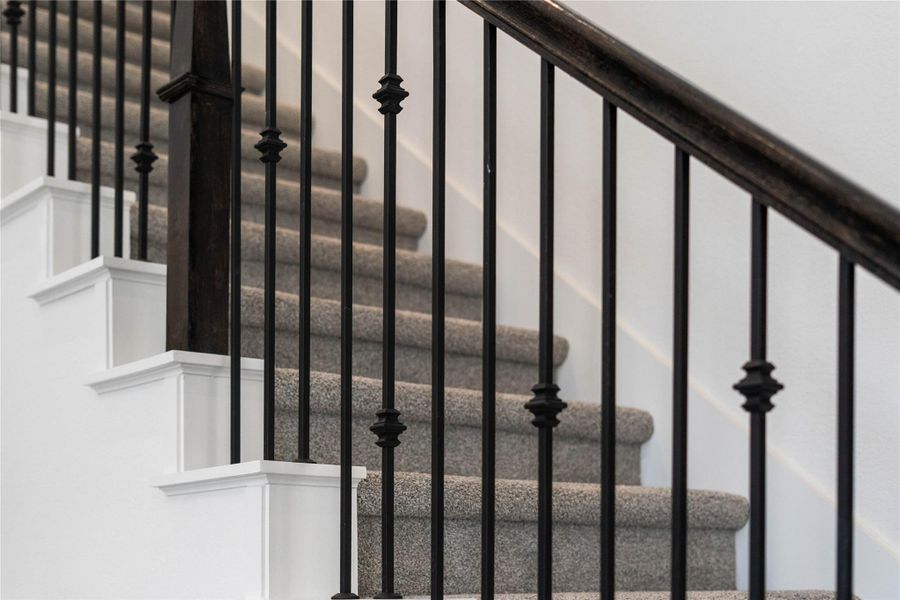 Focus on the quality architectural details of this home, including sleek wrought iron balusters and dark wood handrails. Focus on the quality architectural details of this home, including sleek wrought iron balusters and dark wood handrails.