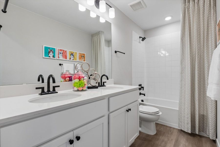 A bathroom with a sink toilet and shower. A bathroom with a sink toilet and shower.