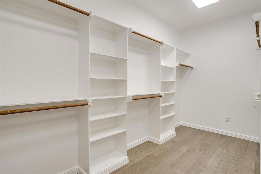 Walk in closet featuring light wood-type flooring