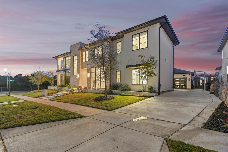 Contemporary house featuring stucco siding and driveway Contemporary house featuring stucco siding and driveway