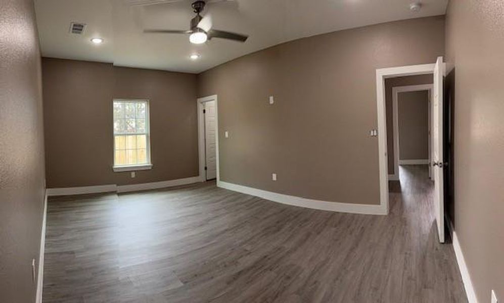 Spare room with a ceiling fan, wood finished floors, baseboards, and recessed lighting Spare room with a ceiling fan, wood finished floors, baseboards, and recessed lighting