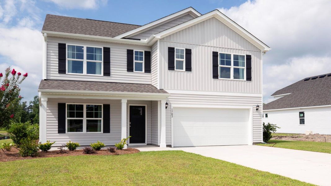 Front exterior of a new home in Saltgrass Landing, Winnabow, NC, highlighting curb appeal (Image 1).