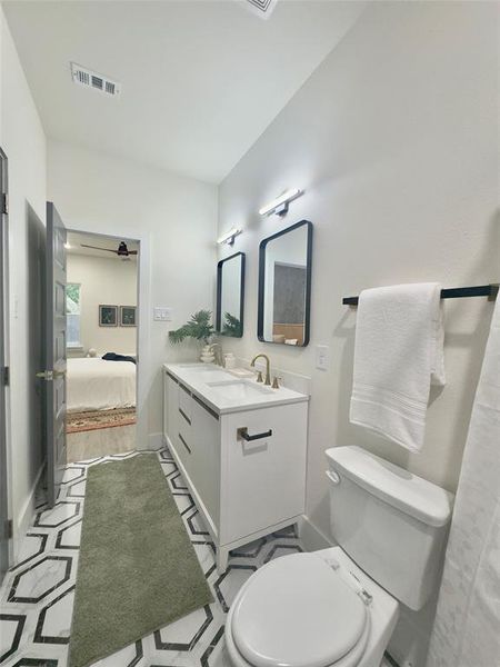 Bathroom featuring vanity and toilet