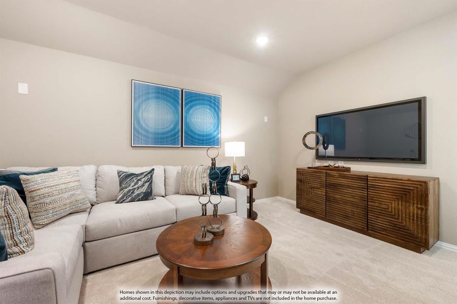 Living room with gray sectional sofa, round wood coffee table, wall-mounted TV, and wood media console on carpet Living room with gray sectional sofa, round wood coffee table, wall-mounted TV, and wood media console on carpet