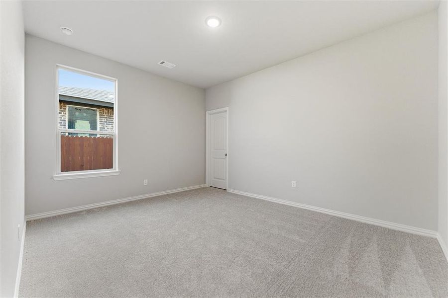 Spare room featuring light carpet and recessed lighting