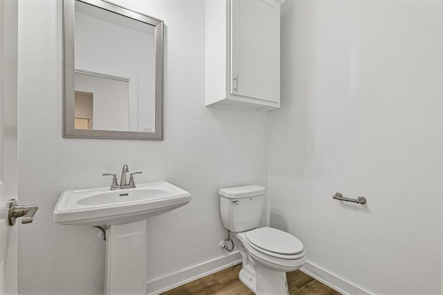 Bathroom featuring hardwood / wood-style floors and toilet Bathroom featuring hardwood / wood-style floors and toilet