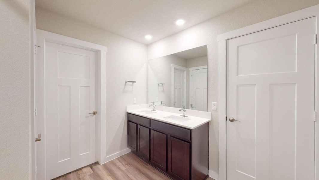A well-appointed bathroom features a double vanity and recessed lighting. A well-appointed bathroom features a double vanity and recessed lighting.