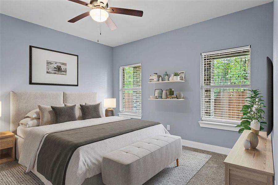 Carpeted bedroom with baseboards and a ceiling fan Carpeted bedroom with baseboards and a ceiling fan