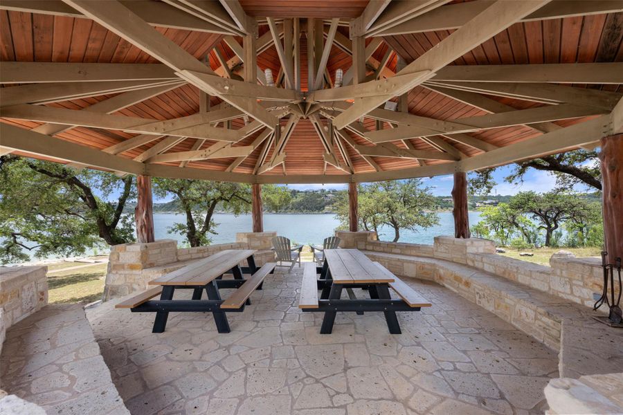 A spacious gazebo with flagstone flooring and lake views offers an idyllic outdoor retreat. A spacious gazebo with flagstone flooring and lake views offers an idyllic outdoor retreat.