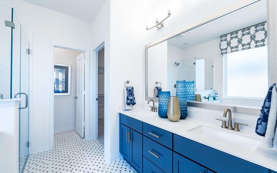 Beautifully appointed primary bathroom featuring dual sinks, extended vanity space, elegant finishes, and tile flooring, thoughtfully designed for comfort, durability, and everyday ease within this private suite. **Photos are representative only and may vary as built.**