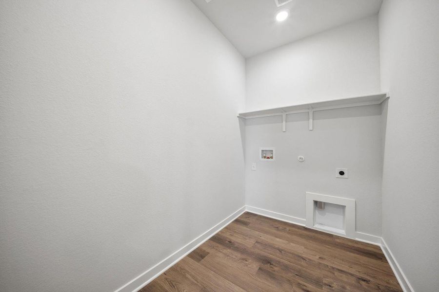 Ready for appliances, this utility room features warm wood flooring and a convenient storage shelf. Ready for appliances, this utility room features warm wood flooring and a convenient storage shelf.