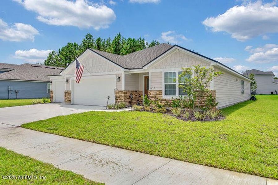 Front exterior of a new home in Edinburgh Village, Jacksonville, FL, highlighting curb appeal (Image 1). Front exterior of a new home in Edinburgh Village, Jacksonville, FL, highlighting curb appeal (Image 1).